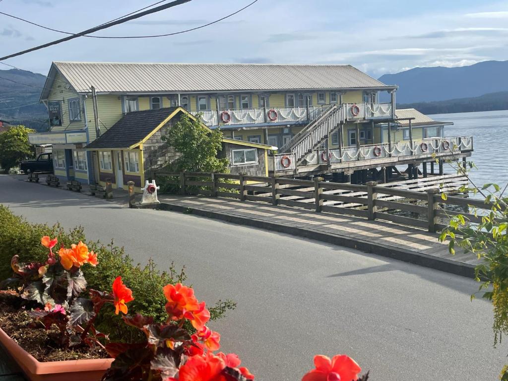 a large building on a dock next to the water at Seine Boat Inn in Alert Bay