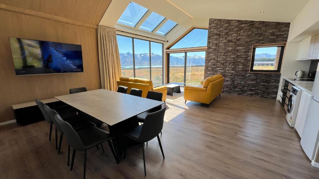 a kitchen and dining room with a table and chairs at Guide Hill Station Lodge in Lake Tekapo