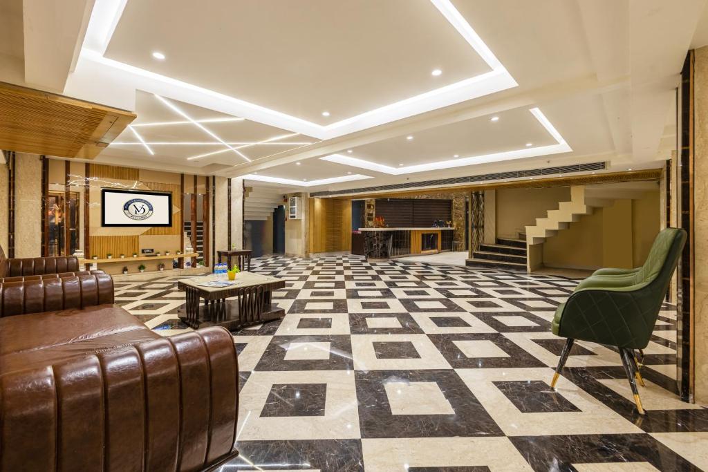 a lobby with a waiting room with a couch and tables at The Vanson Delite "Newly Rebuilt 2026" - Near New Delhi Station & Connaught Place in New Delhi