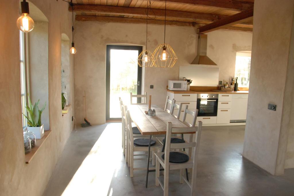 a kitchen and dining room with a table and chairs at Drängagården in Klagstorp
