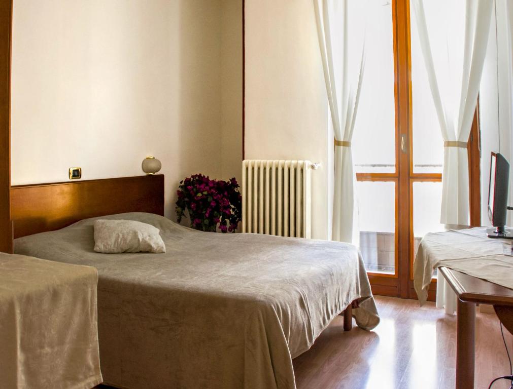 Postel nebo postele na pokoji v ubytování Domus Hotel