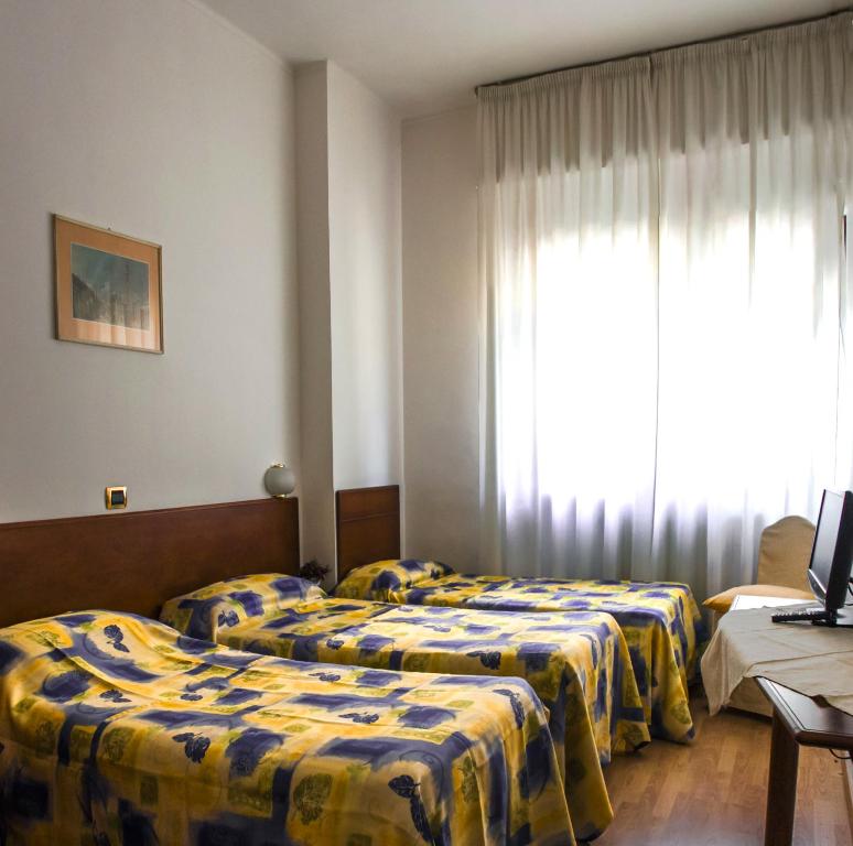 Postel nebo postele na pokoji v ubytování Domus Hotel