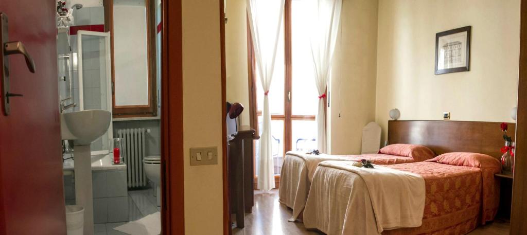 Postel nebo postele na pokoji v ubytování Domus Hotel