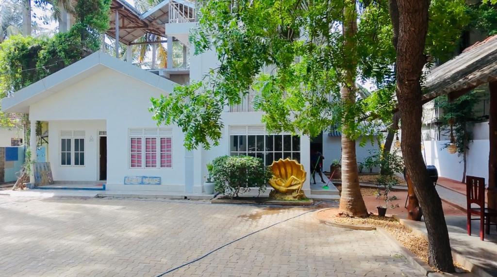 a building with a yellow fountain in front of it at The Beach House , Nilaveli , Trincomalee in Trincomalee