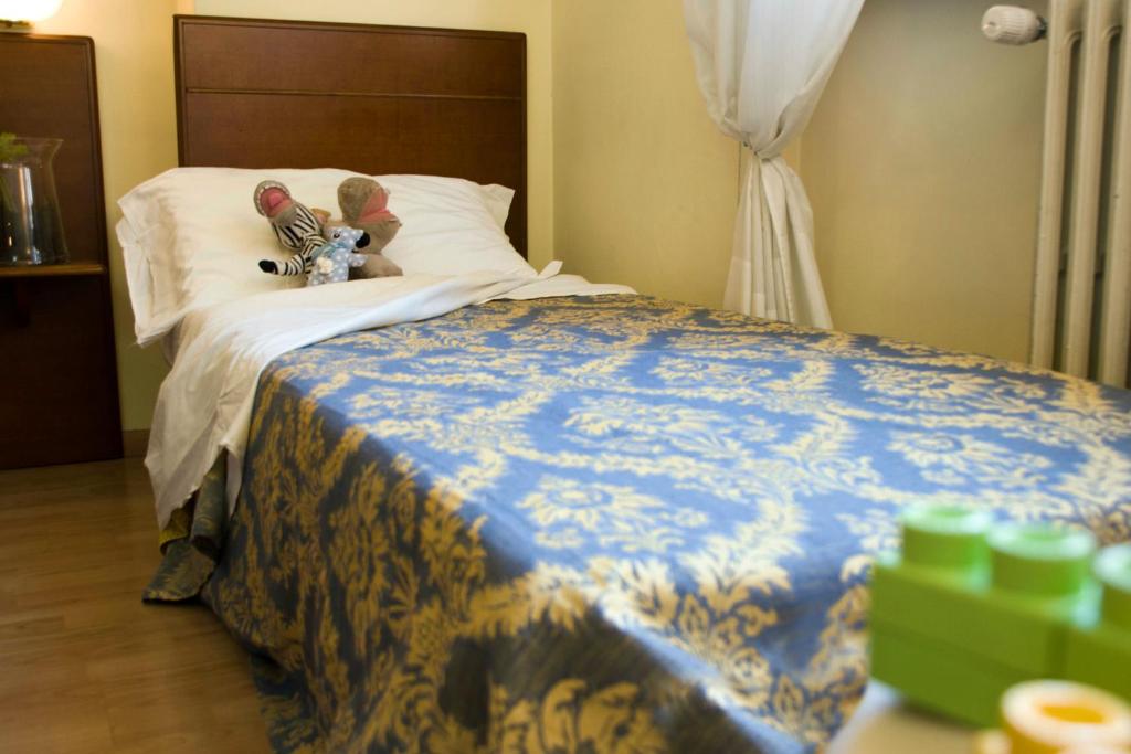 Postel nebo postele na pokoji v ubytování Domus Hotel