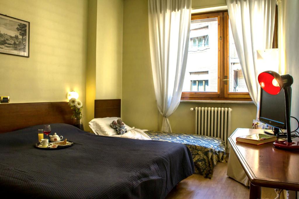 Postel nebo postele na pokoji v ubytování Domus Hotel
