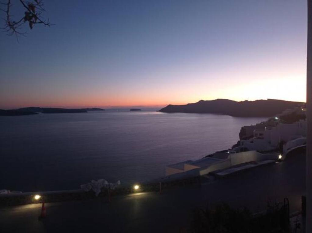 a sunset over a large body of water at Sensia villa with Hot tub and Caldera View in Oia