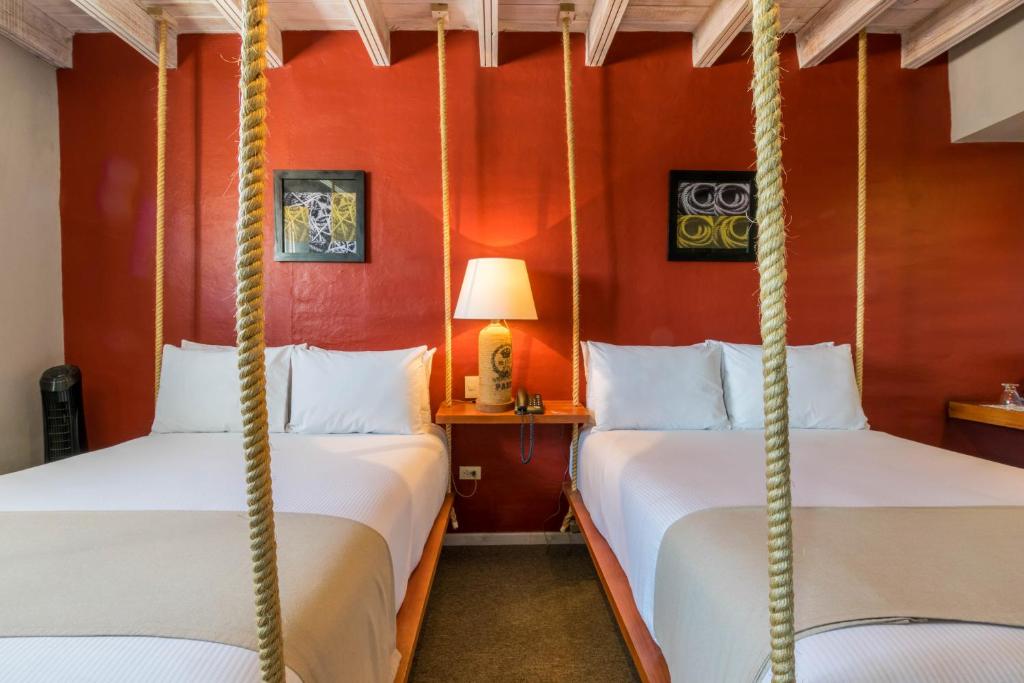 a bedroom with two lamps and a bed at Hotel Damiana Boutique in Querétaro