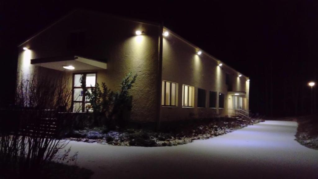 a building with lights on the side of it at night at Immalanjärvi in Imatra