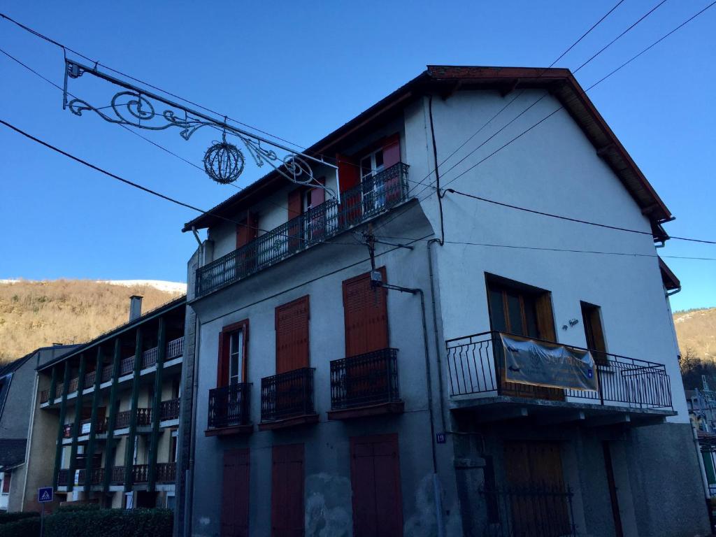 a large white building with balconies on a street at Poles Apart in Ax-les-Thermes