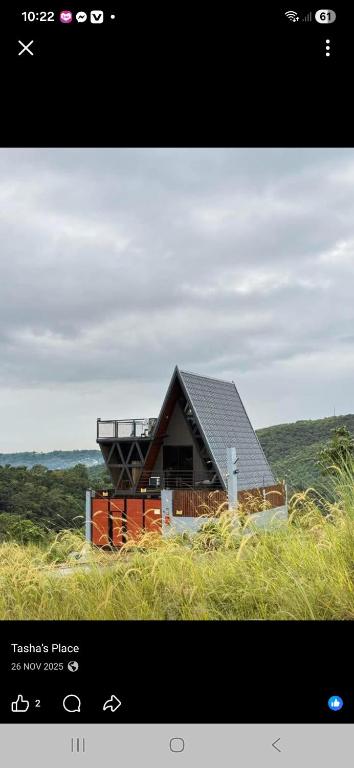 a house with a roof on top of a field at 33 0VG by Tasha's Place in Antipolo