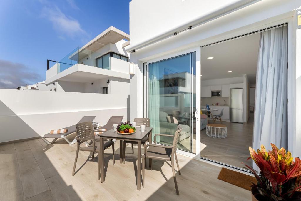 a dining room with a table and chairs on a balcony at Merlin 14 V1 in Playa Honda
