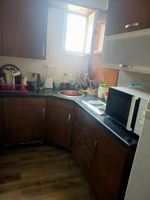 a kitchen with a sink and a counter top at فيلا in Sheikh Zayed