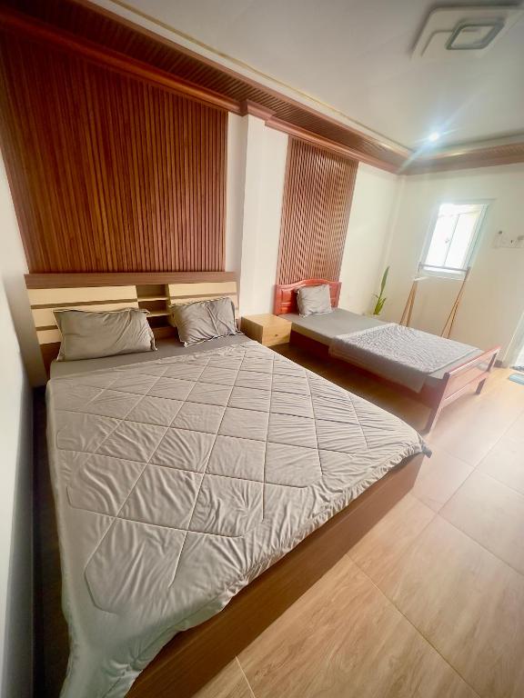 a bedroom with a large bed and a mattress at homestay SunMoon 14 Lê Lợi in Phan Thiet