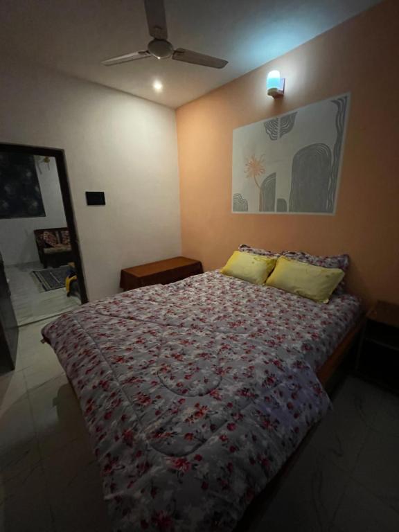 a bedroom with a bed and a ceiling fan at Lotus home in Jaigaon