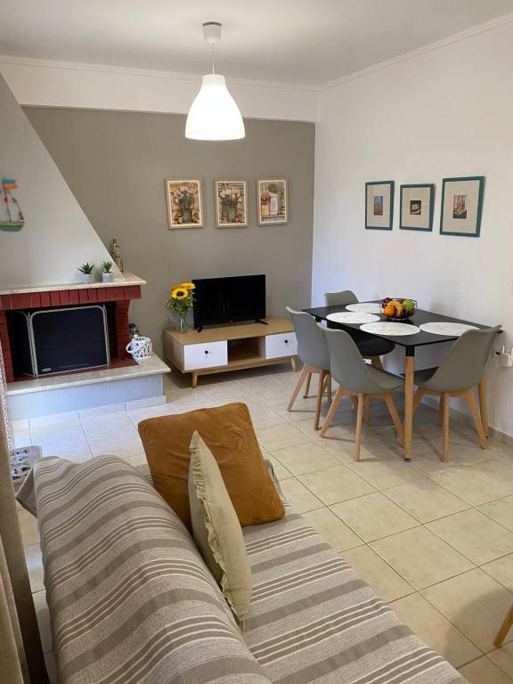 a living room with a table and a dining room at Vereniki 1 in Kriopigi