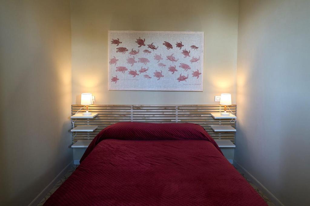 a bedroom with a bed with a red blanket at Artop in Messina