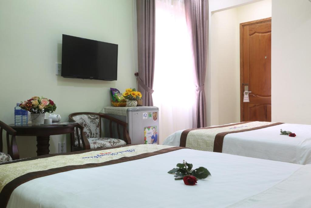Postel nebo postele na pokoji v ubytování Thành Hoàng Châu Boutique Hotel