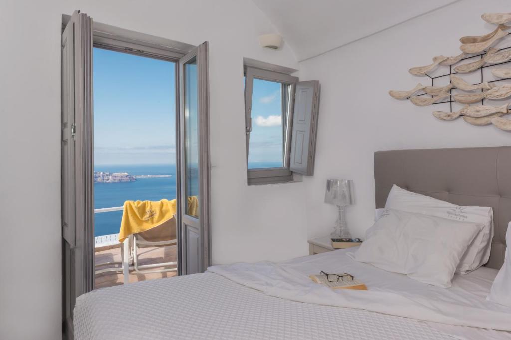 A bed or beds in a room at Iliovasilema Suites