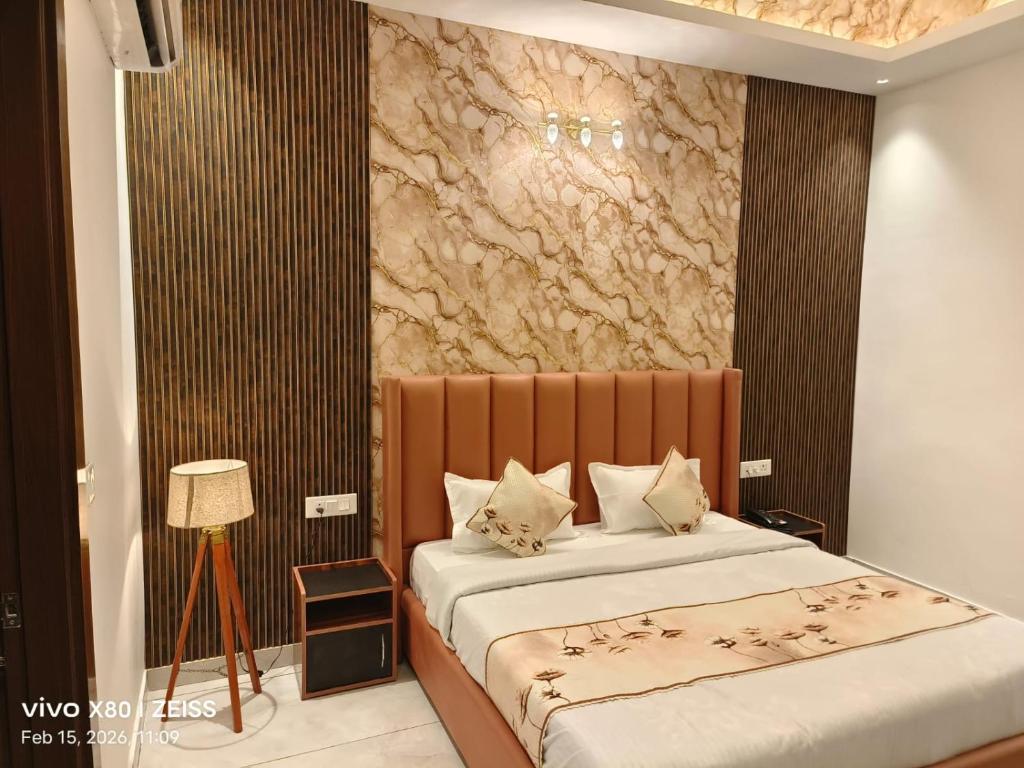 a bedroom with two beds and a stone wall at Hotel Velina in Dhāmpur