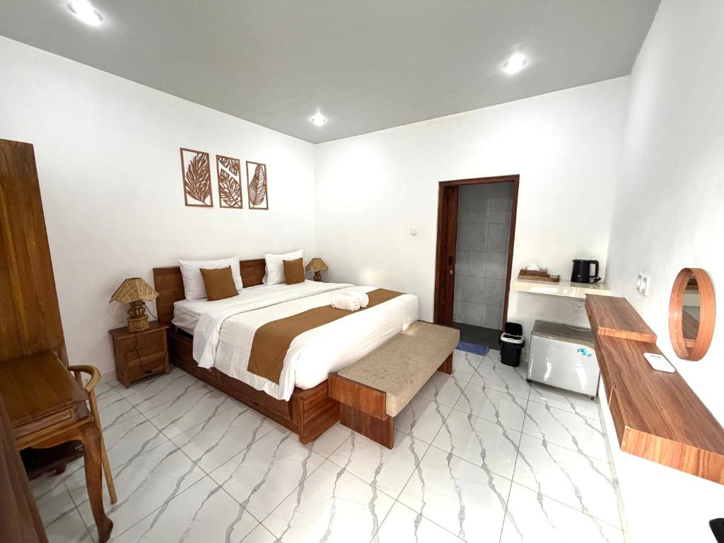 a bedroom with a large bed in a room at Lestari Homestay Jimbaran in Jimbaran