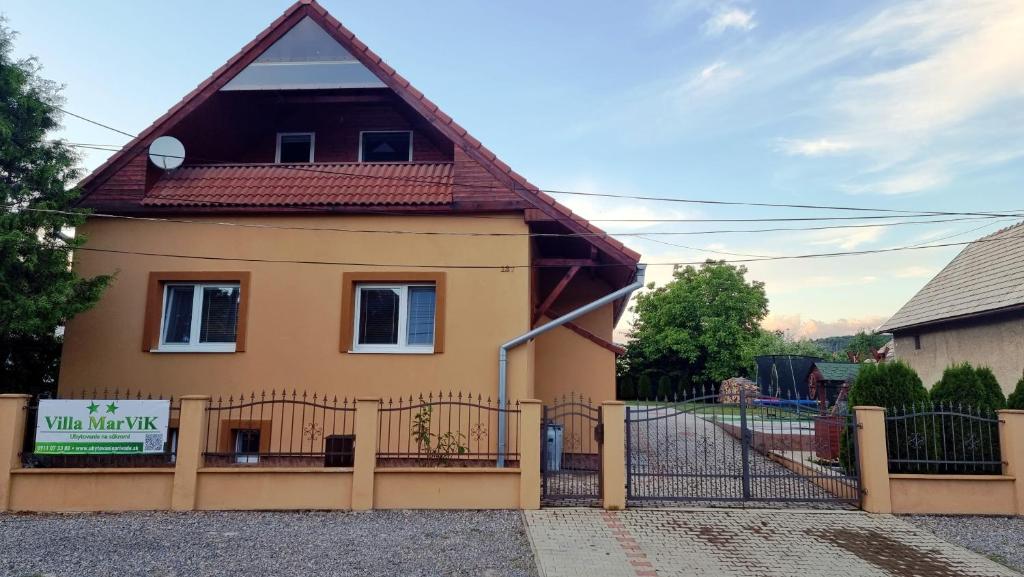 a house with a gate and a fence at Villa MarViK in Lučenec