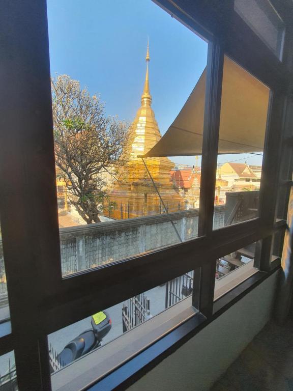 a view of a pagoda from a window at Forge boutique in Chiang Mai