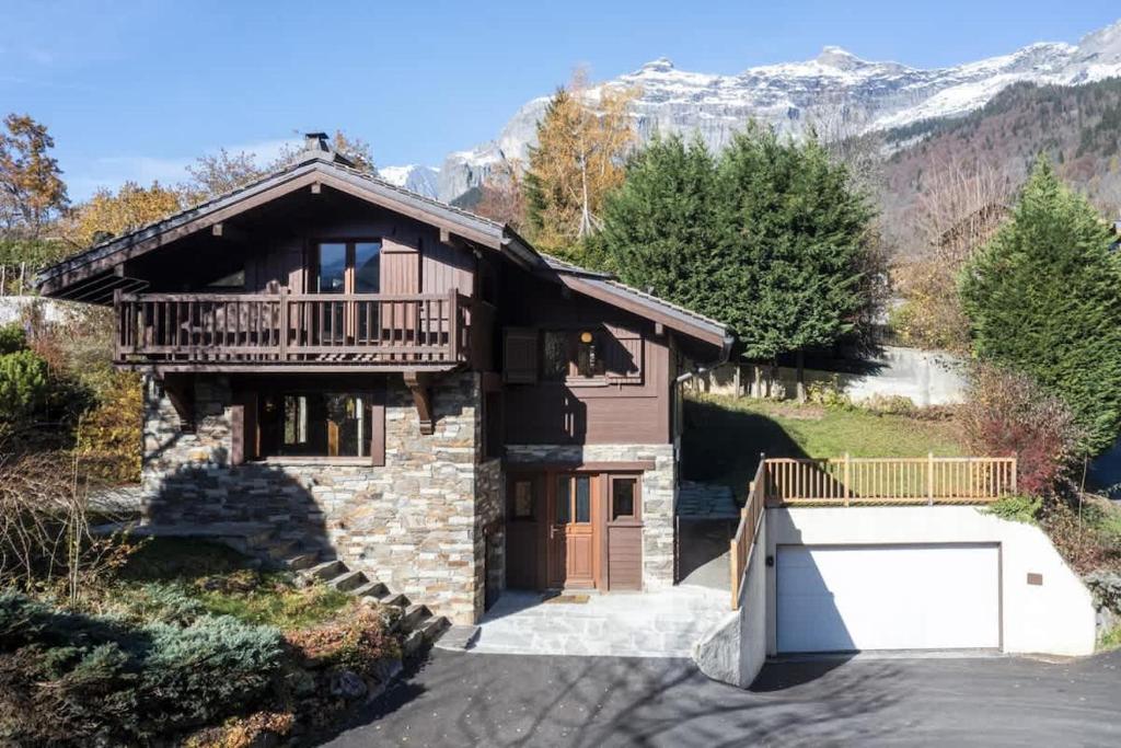 a house with a balcony and a garage at Chalet Cusco in Servoz