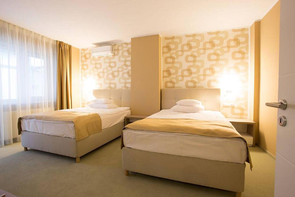 Postel nebo postele na pokoji v ubytování Bruxelles Guesthouse Craiova