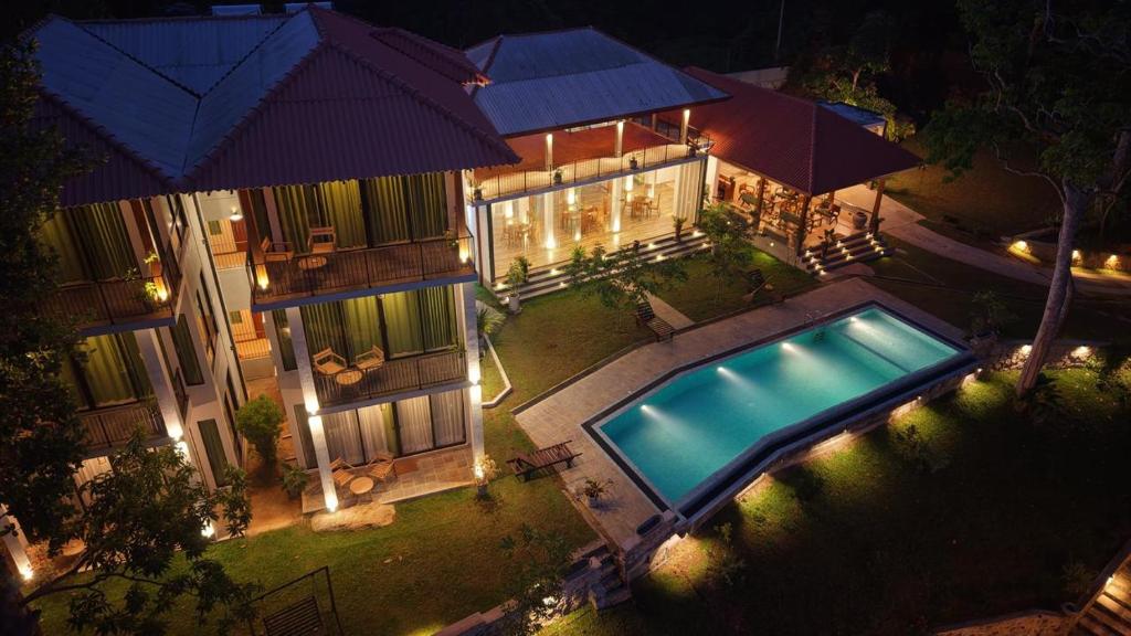 an overhead view of a house with a swimming pool at River Shades Hotel in Hikkaduwa