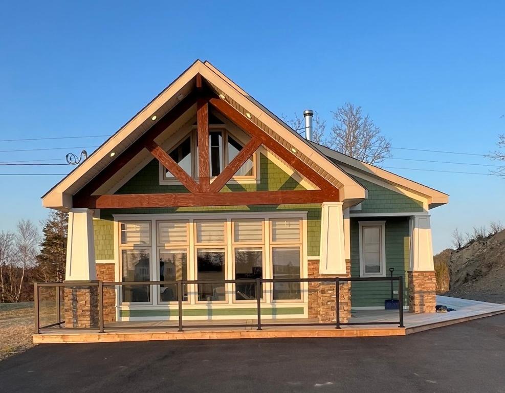 a small house with a screened in porch at The Millhouse Oceanfront Cottage in Summerford