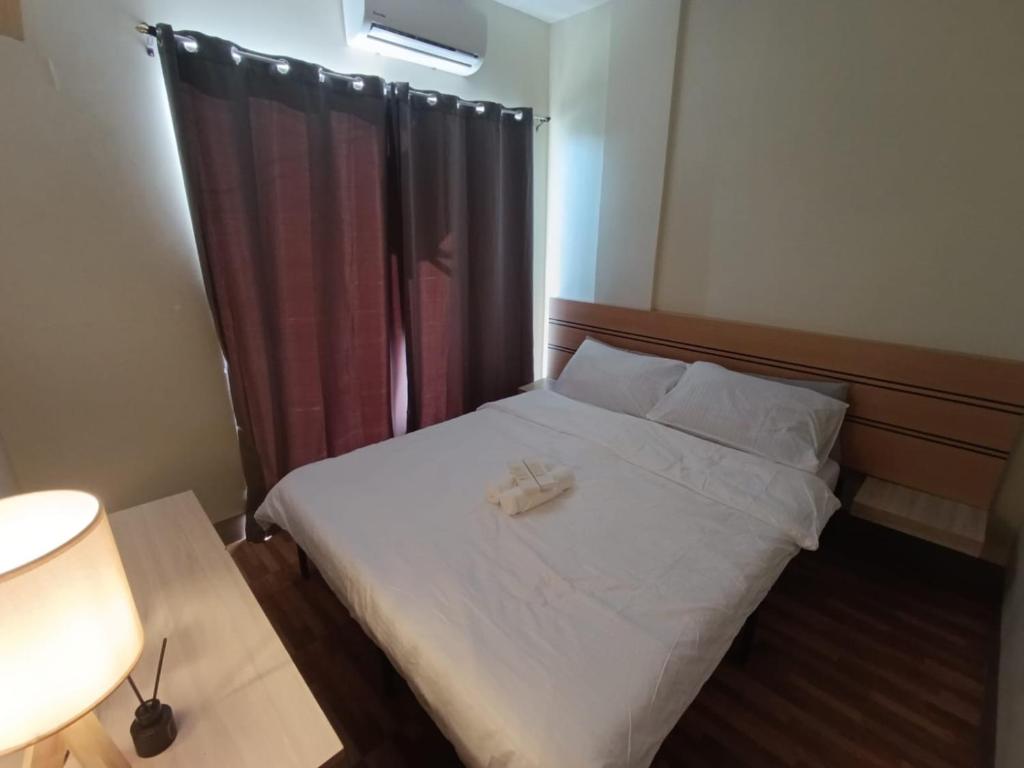 a bedroom with a bed with two towels on it at Goshen Haus in Baclayon