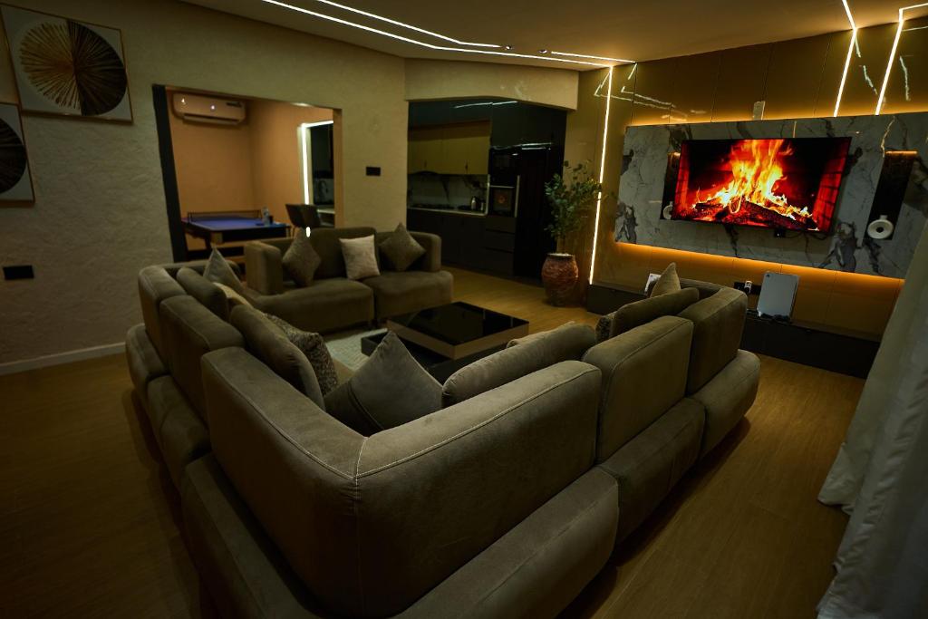 a living room with a couch and a fireplace at Emiez Apartment and Hotel in Benin City