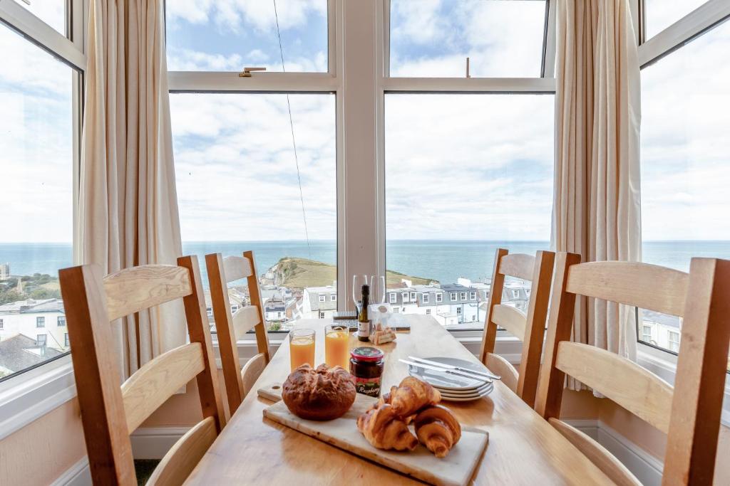 a dining room with a table with a view of the ocean at Ocean View in Ilfracombe