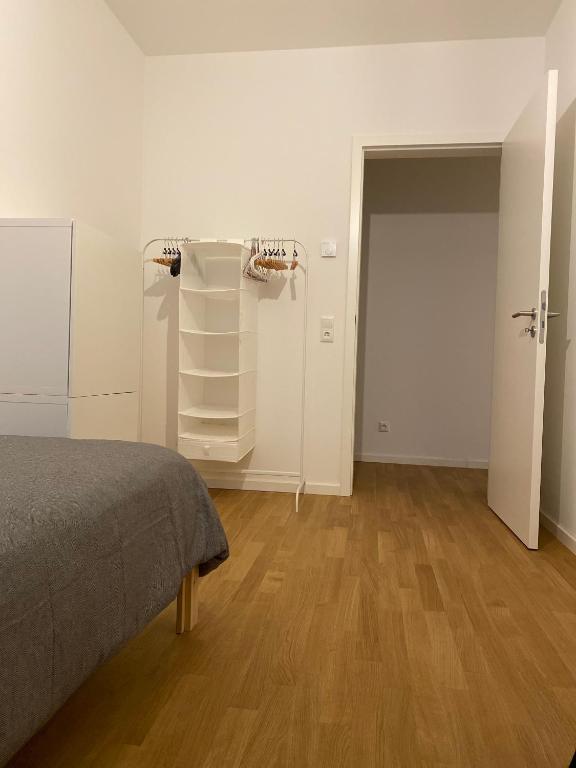 a room with a bed and a closet and a door at Berlin in Niederdorla