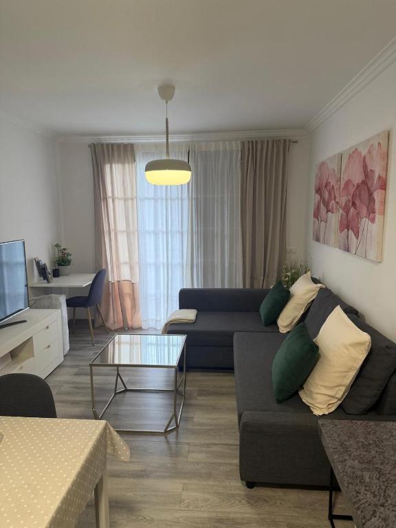 a living room with a couch and a table at Lavilla1XO in Valverde