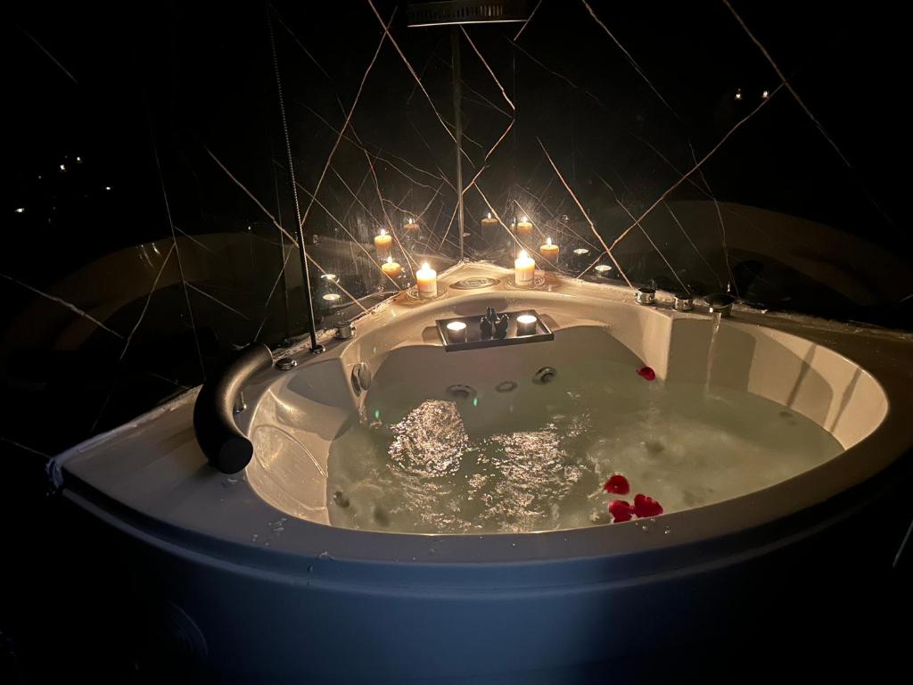 a white bath tub with candles in it at استديو المنام الراقي in Medina