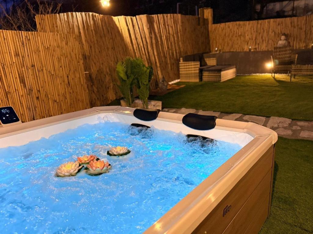 a hot tub with three turtles in it in a backyard at Satori House in Sanremo