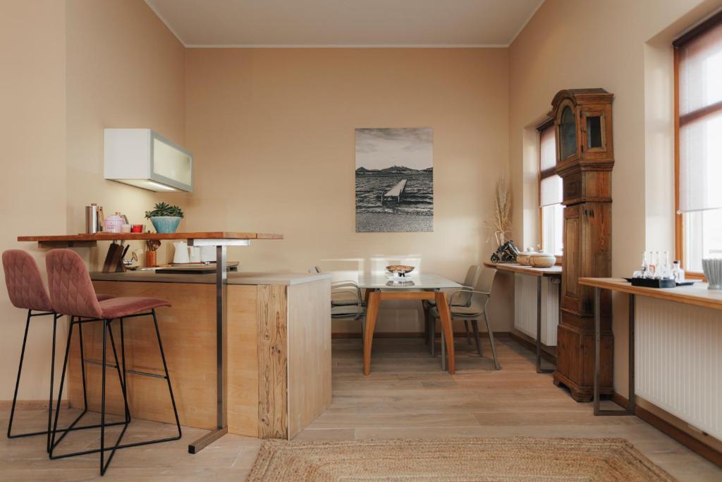 a kitchen with a table and chairs in a room at Seabreeze Suite in Füssen