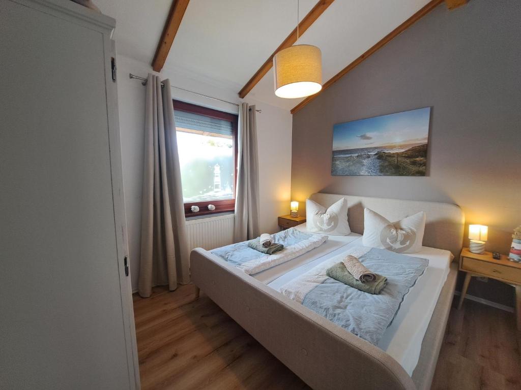 a large bed in a room with a window at Watt'n Traum in Butjadingen