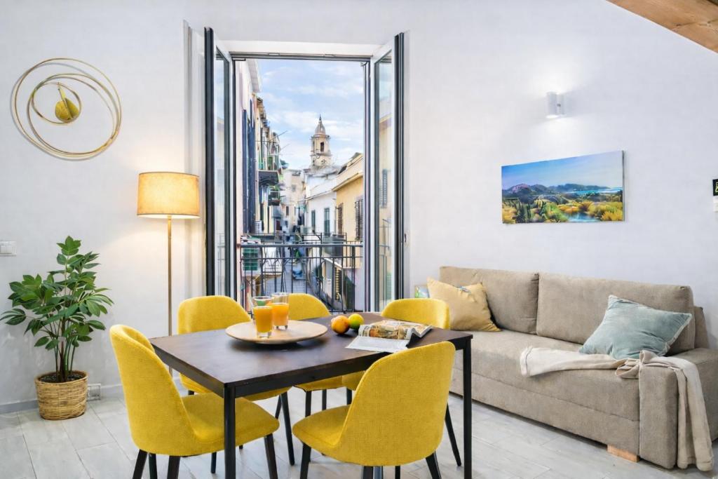 a living room with a couch and a table and chairs at Open Sicily Homes - Near the Central Train Station in Palermo