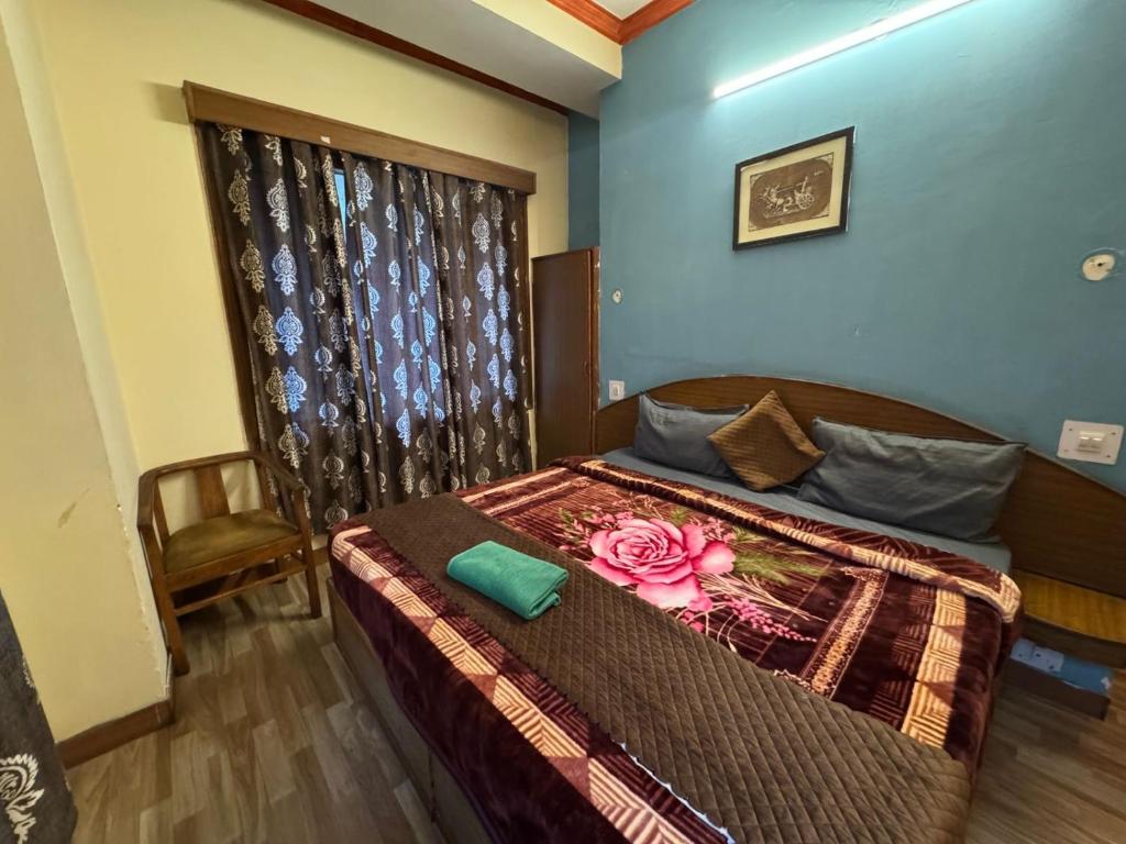 a bedroom with a bed with a flower on it at Hotel Taradavi Regency in Chhota Simla