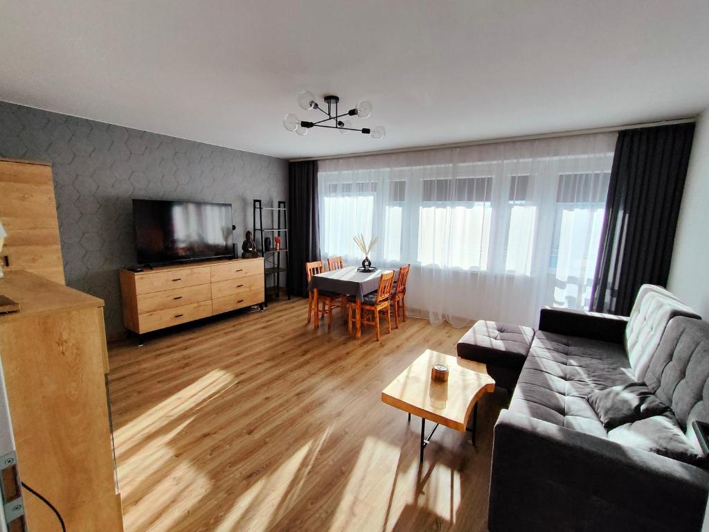 a living room with a couch and a table at Apartament Prudniczanka in Prudnik