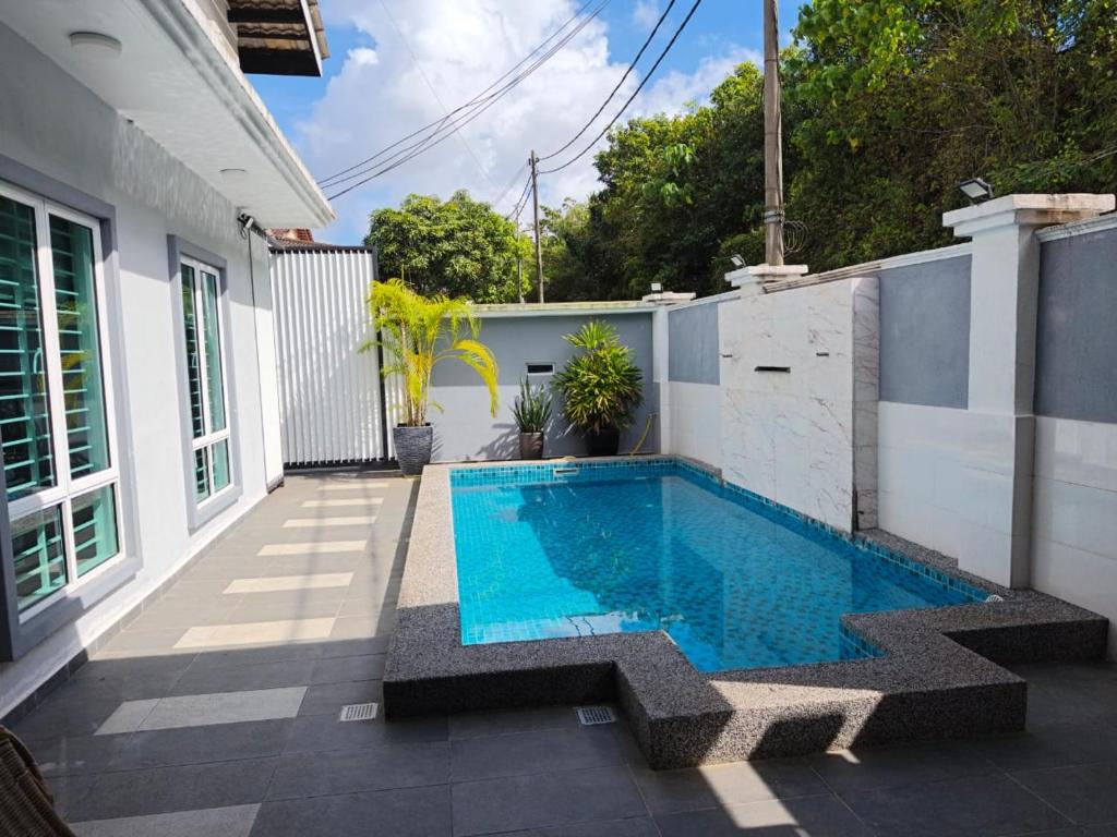 a swimming pool in the backyard of a house at Homestay with pool kuantan in Kuantan