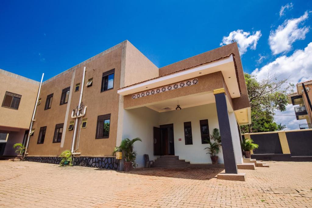 a building on a brick street with a blue sky at Hulcity valley hotel in Kampala