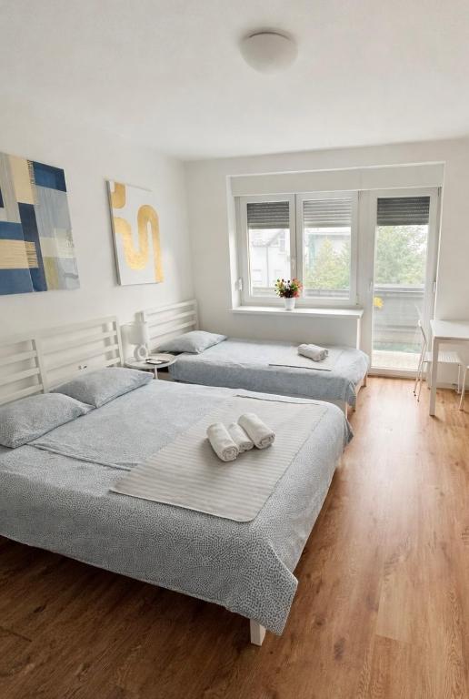a bedroom with two beds with towels on them at Studio apartman ANNI, Self CHECK-IN in Osijek