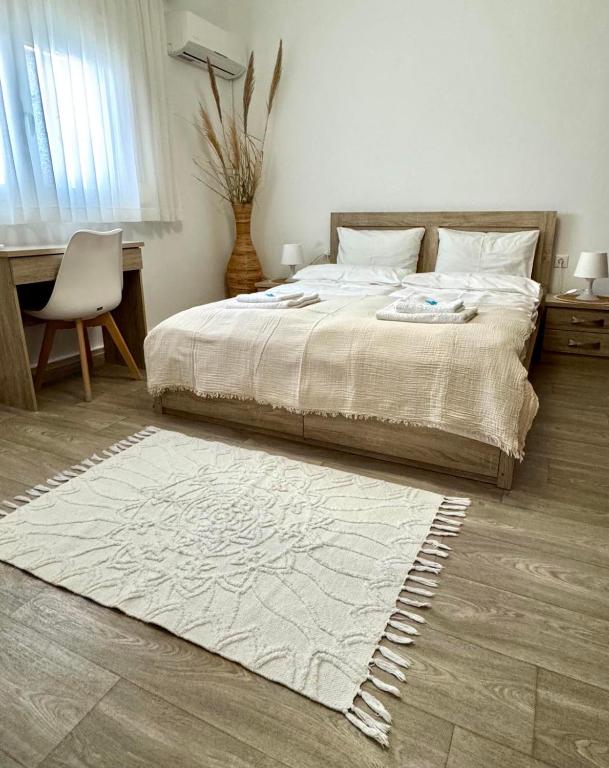 a bedroom with a bed with a rug on the floor at Holiday Dream Artemis Apartment in Mastihari