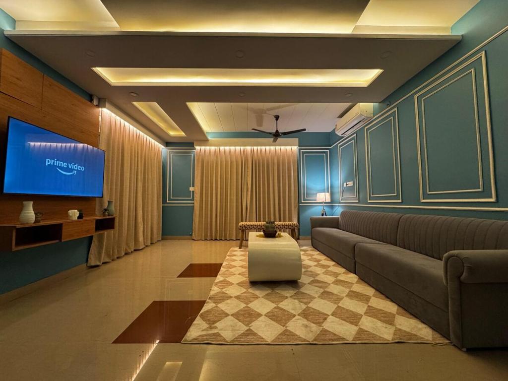 a living room with a couch and a tv at Maison Royale House 3bhk apartment in Jaipur