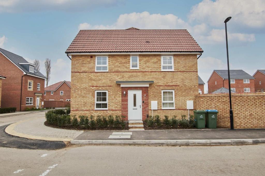 a brick house with a white door on a street at Spacious, 3BR, Coventry House | Sleeps 9 | Parking in Canley