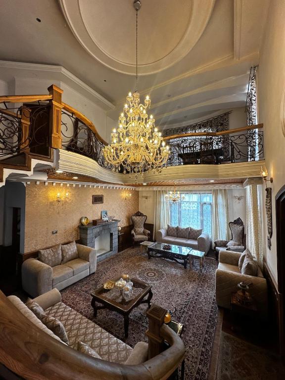 a large living room with a chandelier at The Landing Nest - Villa in Srinagar